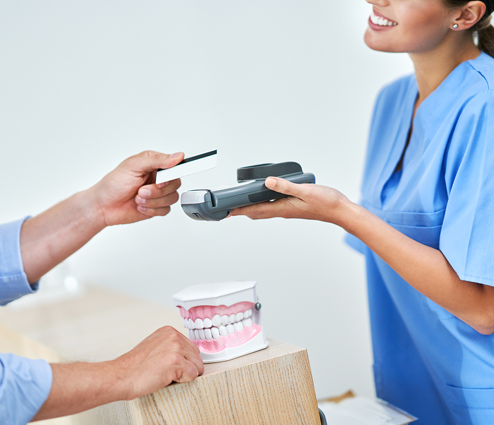 patient-paying-for-dental-visit-in-clinic-2022-05-13-01-36-58-utc.jpg